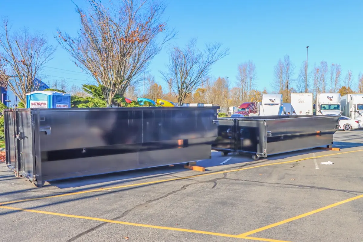 Professional dumpster rental service with roll-off container on residential driveway in Capitola